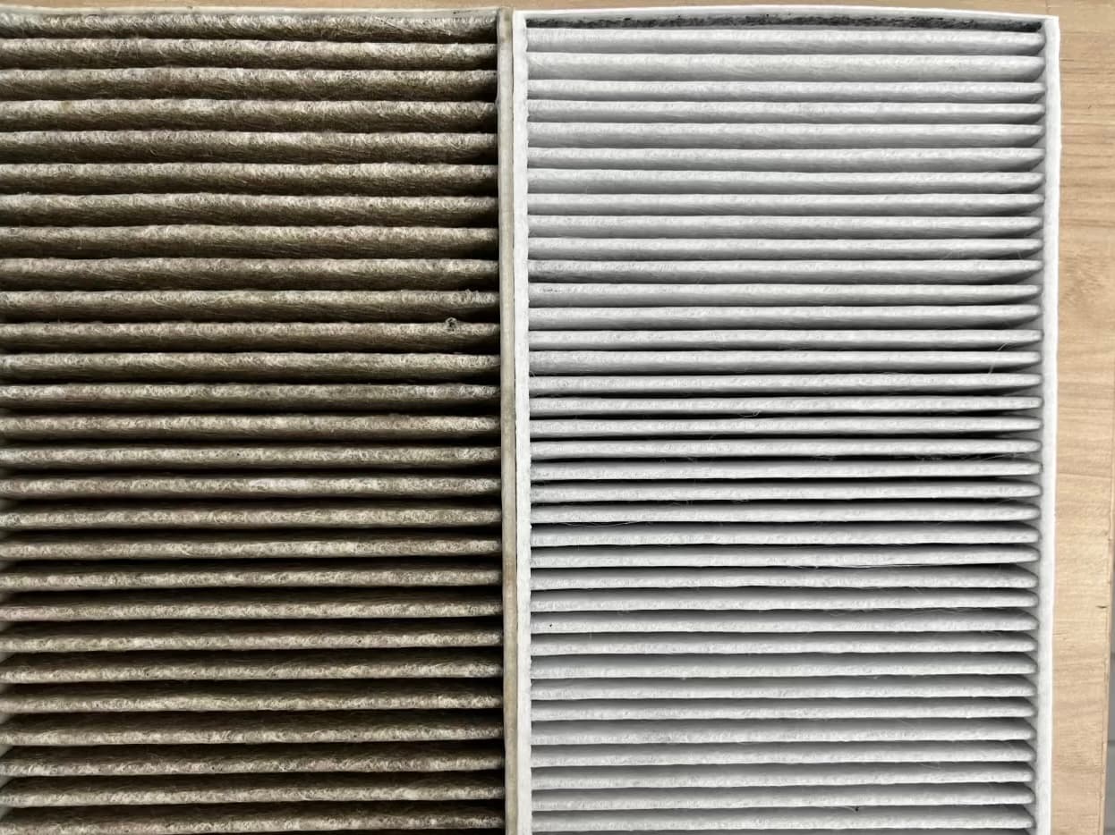 Clean and dirty Model Y cabin air filters placed side by side for comparison