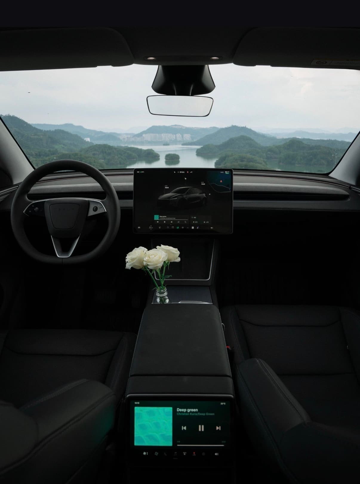 Model Y cabin interior with front seats, center screen, and floor area visible