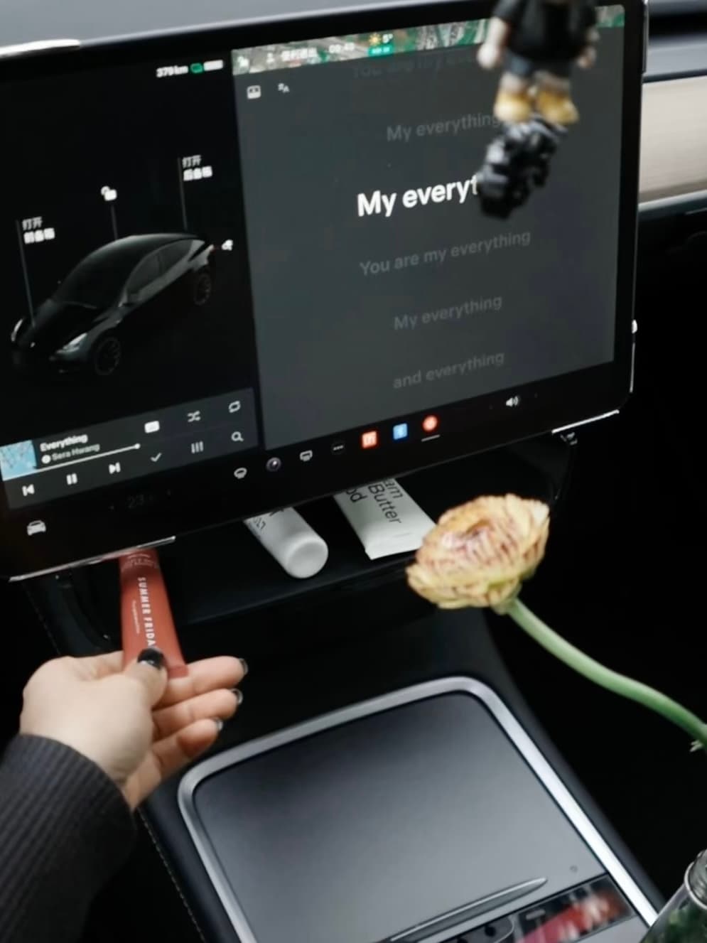 Model Y touchscreen with an under-screen storage tray holding small daily items